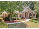 Charming brick home with a well-manicured lawn and lush landscaping at 997 Thousand Oaks Nw Bnd, Kennesaw, GA 30152