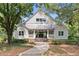 Craftsman-style home with a welcoming front porch, neutral siding, metal roof, and well-maintained landscaping at 997 Thousand Oaks Nw Bnd, Kennesaw, GA 30152