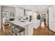 Bright kitchen with white cabinets, stainless appliances, large island with seating, open to living area at 997 Thousand Oaks Nw Bnd, Kennesaw, GA 30152