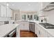 Bright, modern kitchen with an island, stainless steel appliances, white cabinets, and natural light at 997 Thousand Oaks Nw Bnd, Kennesaw, GA 30152
