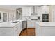 Gourmet kitchen with white cabinets, quartz countertops, herringbone backsplash, and stainless steel appliances at 997 Thousand Oaks Nw Bnd, Kennesaw, GA 30152