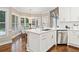 Eat-in kitchen features an island, stainless steel appliances, and a breakfast nook surrounded by windows at 997 Thousand Oaks Nw Bnd, Kennesaw, GA 30152