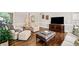 Spacious living room with hardwood floors and an open layout, connecting to the office and kitchen at 997 Thousand Oaks Nw Bnd, Kennesaw, GA 30152