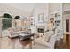 Bright living room with a fireplace, built-in shelving, hardwood floors and comfortable seating at 997 Thousand Oaks Nw Bnd, Kennesaw, GA 30152