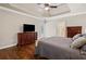 Spacious main bedroom featuring a tray ceiling, hardwood floors, and a door to the outside at 997 Thousand Oaks Nw Bnd, Kennesaw, GA 30152