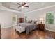 Spacious main bedroom with trey ceiling, hardwood floors, and natural light, leading to en suite bathroom at 997 Thousand Oaks Nw Bnd, Kennesaw, GA 30152