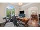 Bright office space with a large window, hardwood floors, and a view of the dining room at 997 Thousand Oaks Nw Bnd, Kennesaw, GA 30152