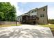 Expansive backyard featuring a basketball court, patio, lush lawn, and multi-level deck for outdoor entertaining at 3589 Tamerton Trce, Buford, GA 30519