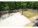 Aerial view of backyard with basketball court, fenced yard, and trees at 3589 Tamerton Trce, Buford, GA 30519