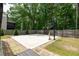 Backyard basketball court surrounded by lush greenery, perfect for outdoor activities and Gathering fun at 3589 Tamerton Trce, Buford, GA 30519