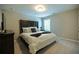 Inviting bedroom with a large bed, soft lighting, and neutral tones creating a serene and relaxing atmosphere at 3589 Tamerton Trce, Buford, GA 30519