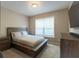 Bedroom with modern furnishings, neutral walls, and natural light at 3589 Tamerton Trce, Buford, GA 30519