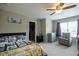 Well-lit bedroom with carpet floors, ceiling fan, comfy chair, and a side table perfect for a restful night at 3589 Tamerton Trce, Buford, GA 30519
