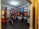 Well-equipped home gym featuring weightlifting equipment, exercise bike, and walls decorated with framed sports jerseys at 3589 Tamerton Trce, Buford, GA 30519