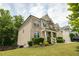 Charming two-story home with brick and beige siding, lush landscaping, and inviting front porch at 3589 Tamerton Trce, Buford, GA 30519