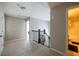 Upstairs hallway with neutral walls and carpet leads to bedrooms and bathrooms at 3589 Tamerton Trce, Buford, GA 30519