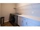 Bright laundry room equipped with a side-by-side washer and dryer, storage, and a folding counter at 3589 Tamerton Trce, Buford, GA 30519