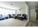 Cozy living room featuring plush seating, carpet, and a large window for plenty of natural light at 3589 Tamerton Trce, Buford, GA 30519