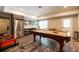 Entertainer's dream: recreation area with a pool table, stainless steel appliances, bar area, and outside access at 3589 Tamerton Trce, Buford, GA 30519