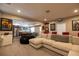 Spacious recreation room with a large sectional sofa, posters, and an opening to the kitchen at 3589 Tamerton Trce, Buford, GA 30519