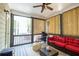 Inviting sunroom featuring a ceiling fan, comfortable seating and natural light at 3589 Tamerton Trce, Buford, GA 30519