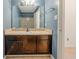 Well-lit bathroom featuring a wooden vanity, cream countertops, and a large mirror at 1025 Whitfield Ct, Smyrna, GA 30080