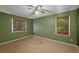 Cozy bedroom with natural light from two windows, complemented by a ceiling fan at 1025 Whitfield Ct, Smyrna, GA 30080