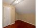 Compact bedroom with hardwood floors and a door for privacy, suitable as a guest room or home office at 1025 Whitfield Ct, Smyrna, GA 30080