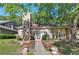 Charming single-story home featuring a stone chimney, well-kept lawn, and a vibrant red front door at 1025 Whitfield Ct, Smyrna, GA 30080