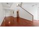 Open-concept living area with gleaming hardwood floors and a staircase leading to the upper level at 1025 Whitfield Ct, Smyrna, GA 30080
