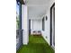 Cozy balcony featuring turf flooring, an exterior wall, a bench, and outdoor lighting at 395 Pratt Drive Se # No 802, Atlanta, GA 30315
