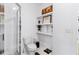 Bathroom featuring a toilet next to shelving with elegant decor, complemented by white hexagon tile flooring at 395 Pratt Drive Se # No 802, Atlanta, GA 30315