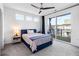 Bedroom featuring a ceiling fan, a blue bed, and balcony sliding doors that bring the outside in at 395 Pratt Drive Se # No 802, Atlanta, GA 30315