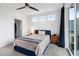 Bedroom featuring a blue bed, modern lighting, and balcony sliding doors for a tranquil retreat at 395 Pratt Drive Se # No 802, Atlanta, GA 30315