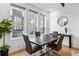 Cozy dining area featuring a wooden table, four chairs, hardwood floors, and large windows at 395 Pratt Drive Se # No 802, Atlanta, GA 30315
