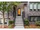 Charming townhome entrance with brick facade, leading up to a stylish front door with metal banisters at 395 Pratt Drive Se # No 802, Atlanta, GA 30315