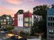 Modern townhome exterior featuring brick and metal accents with ample windows and a well-lit facade at dusk at 395 Pratt Drive Se # No 802, Atlanta, GA 30315