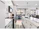 Bright kitchen featuring a marble countertop, stainless steel appliances, and sliding glass doors to an outdoor balcony at 395 Pratt Drive Se # No 802, Atlanta, GA 30315
