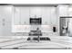 Bright kitchen with marble countertops, stainless steel appliances, and a sink overlooking the living space at 395 Pratt Drive Se # No 802, Atlanta, GA 30315