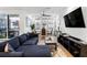 Inviting living room featuring a comfortable blue sectional sofa, large windows and hardwood floors at 395 Pratt Drive Se # No 802, Atlanta, GA 30315