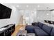 Comfortable living room features a blue sectional sofa, hardwood floors, and a stylish entertainment center at 395 Pratt Drive Se # No 802, Atlanta, GA 30315