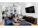Spacious living room featuring hardwood floors, modern decor, a comfortable sofa, and ample natural light at 395 Pratt Drive Se # No 802, Atlanta, GA 30315