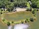 Picturesque aerial view of the community lake highlighting the beach and surrounding trees at 4614 Ridge Dr, Pine Lake, GA 30072