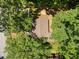 Aerial view of the house showing the roof and surrounding trees providing ample shade at 4614 Ridge Dr, Pine Lake, GA 30072