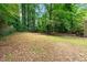 Spacious backyard area featuring grass, landscaping and a partially fenced yard at 4614 Ridge Dr, Pine Lake, GA 30072