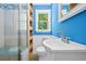 Bright bathroom with a stylish vanity, decorative mirror and modern shower at 4614 Ridge Dr, Pine Lake, GA 30072