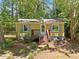 Charming single-story home with a quaint front porch and walkway surrounded by lush greenery at 4614 Ridge Dr, Pine Lake, GA 30072
