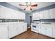 Bright kitchen with white cabinets, stainless steel appliances, and sleek countertops at 4614 Ridge Dr, Pine Lake, GA 30072