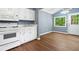 Eat-in kitchen with lots of white cabinets, modern appliances, and an adjacent door to the exterior at 4614 Ridge Dr, Pine Lake, GA 30072