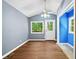 Bright living room with wood flooring, blue walls, and natural light streaming through the window at 4614 Ridge Dr, Pine Lake, GA 30072